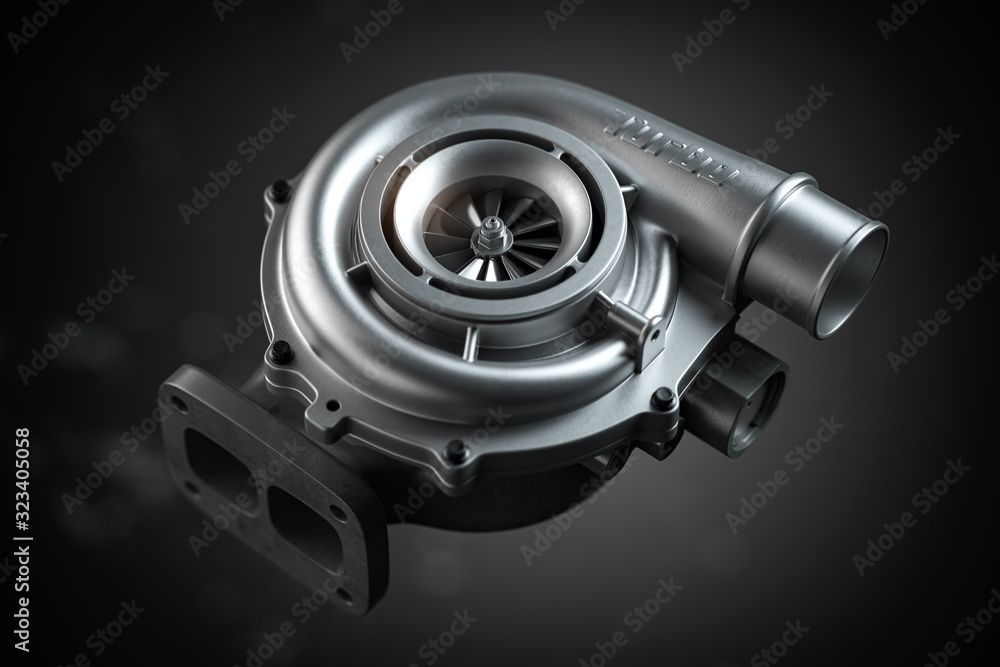 Turbosprężarka co to jest. Na cieno szarym tle leży nowiutka srebrzyście lśniąca turbosprężarka. Jej kształt przypomina spiralnie zwiniętą rurę o średnicy około 5 centymetrów.