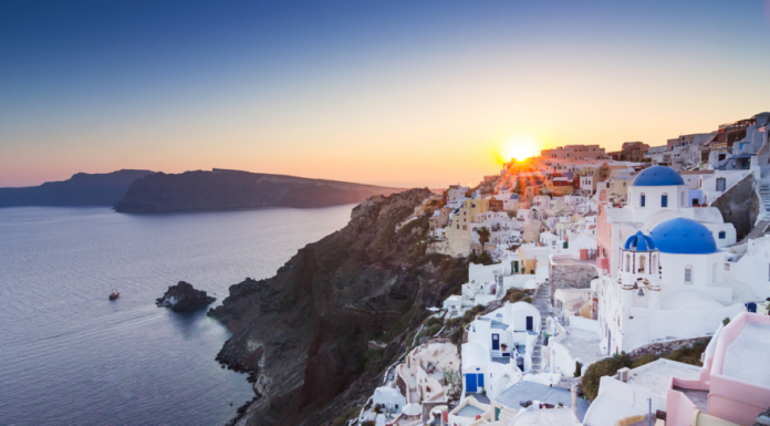 Urlop wypoczynkowy w 2024 roku, piękny widok miasta na greckiej wyspie o zachodzie słońca - wakacje jesienią