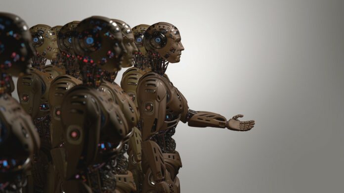 Humanoidalny robot Tesli - grupa humanoidalnych robotów stoi obrócona w jednym kierunku, jeden z nich wyciąga rękę