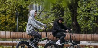 dofinansowanie do roweru elektrycznego, dwóch uśmiechniętych mężczyzn jedzie rowerami elektrycznymi