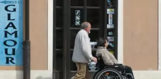 Aktywny Samorząd 2024, mężczyzna wiezie kobietę na wózku inwalidzkim