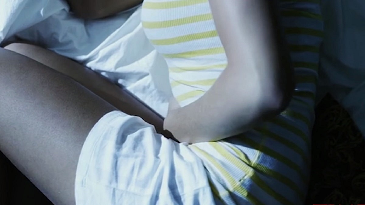 Tajemnice wanilii - kobieta w pozycji embrionalnej kurczowo trzyma się za brzuch, leżąc nocą w łóżku.